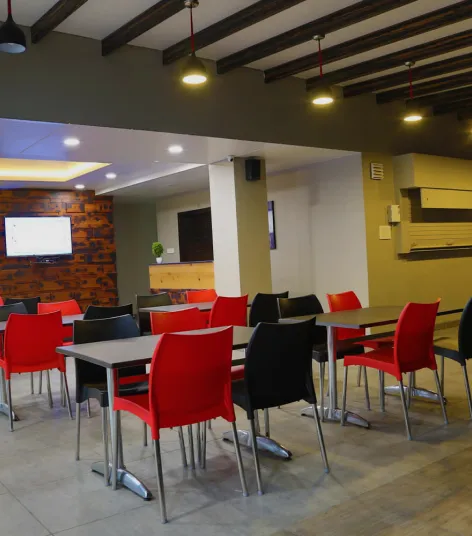Office dining area with tables and red chairs